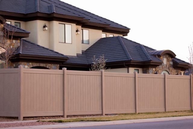 residential brown vinyl fence street view