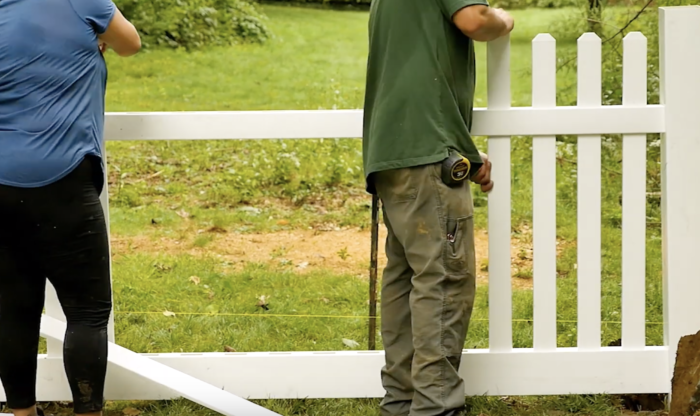 Step 4 of vinyl fence installation inserting fence pickets