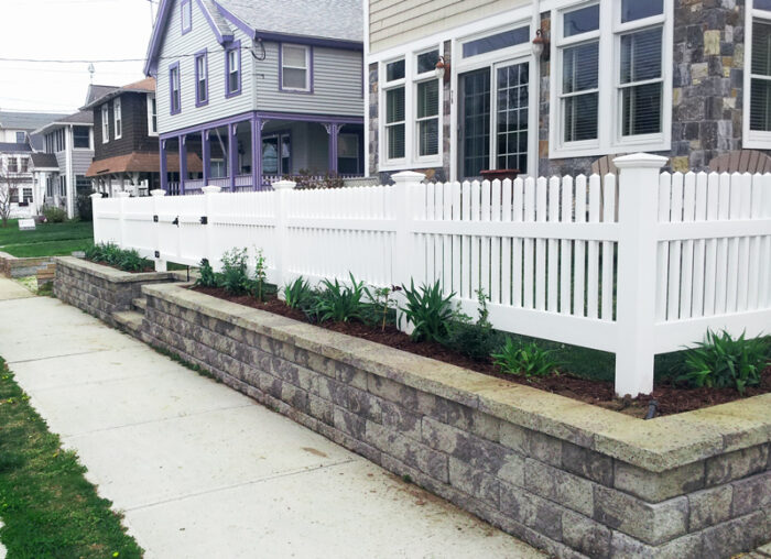 residential white vinyl fence sidewalk view
